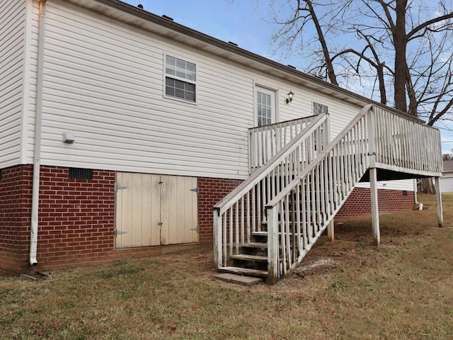 view of property exterior featuring a yard and a deck