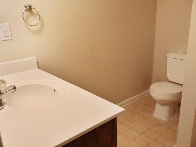 bathroom featuring tile patterned flooring, vanity, and toilet