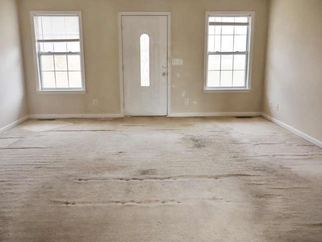 entryway with light carpet and a healthy amount of sunlight