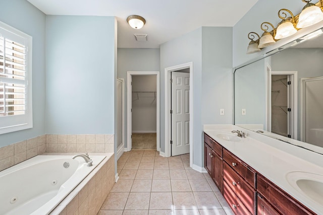 bathroom featuring tile patterned floors, vanity, and shower with separate bathtub