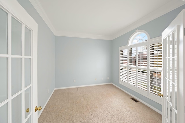 carpeted spare room featuring ornamental molding