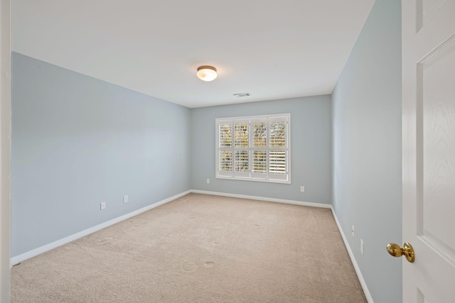 unfurnished room featuring light carpet