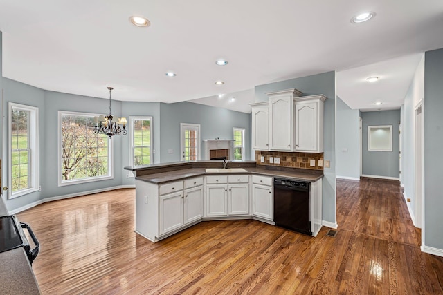 kitchen with white cabinets, sink, a wealth of natural light, and black appliances