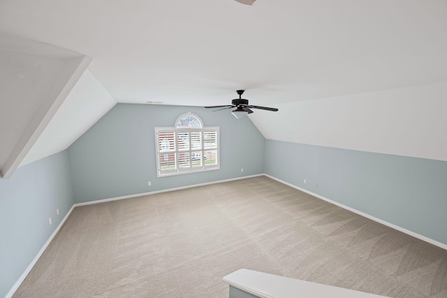 additional living space featuring carpet flooring, ceiling fan, and lofted ceiling