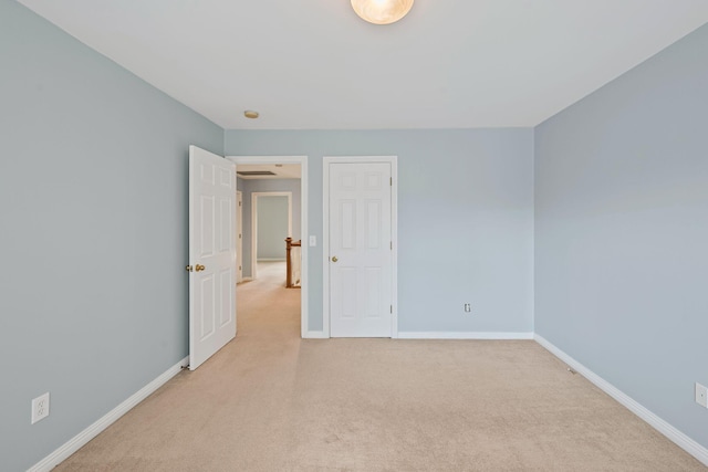 unfurnished room with light carpet