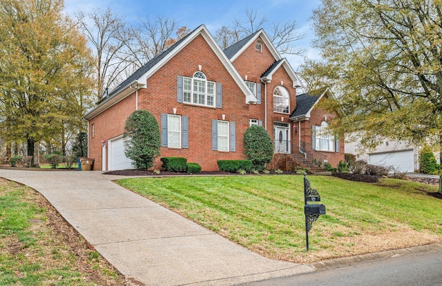 view of property with a garage and a front lawn