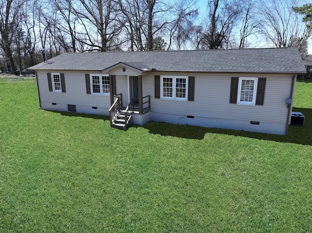 view of front facade with a shingled roof, a front yard, crawl space, and central air condition unit