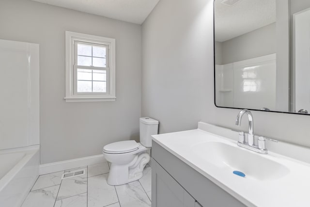 full bathroom featuring a textured ceiling, toilet, vanity, baseboards, and marble finish floor