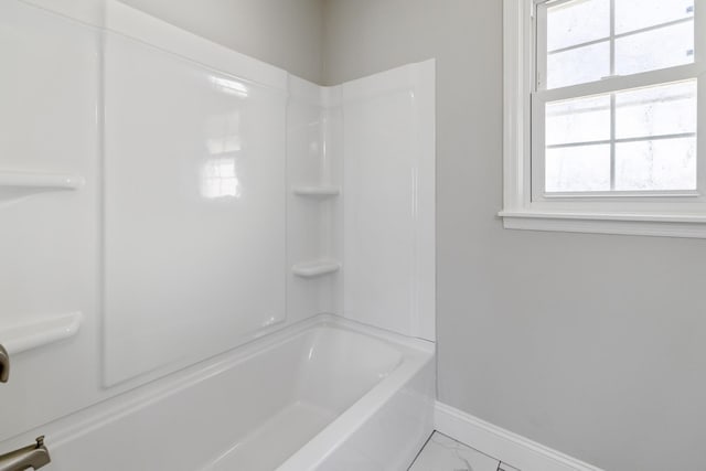 full bath with marble finish floor, baseboards, and bathtub / shower combination