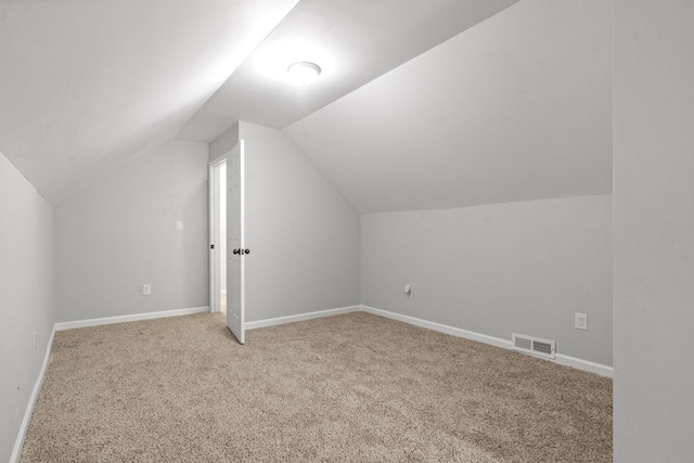 bonus room with carpet floors and lofted ceiling