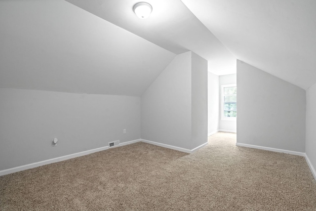 bonus room with carpet and vaulted ceiling