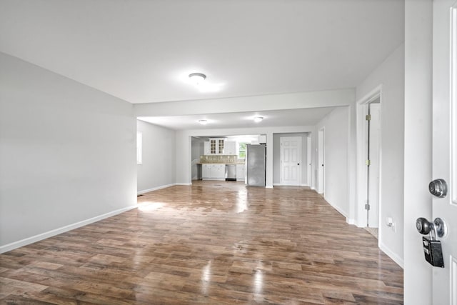 unfurnished living room with dark hardwood / wood-style floors