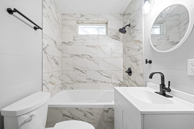 full bathroom featuring toilet, vanity, and tiled shower / bath