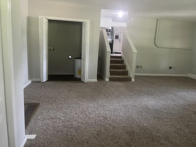 basement featuring carpet flooring and stainless steel refrigerator with ice dispenser