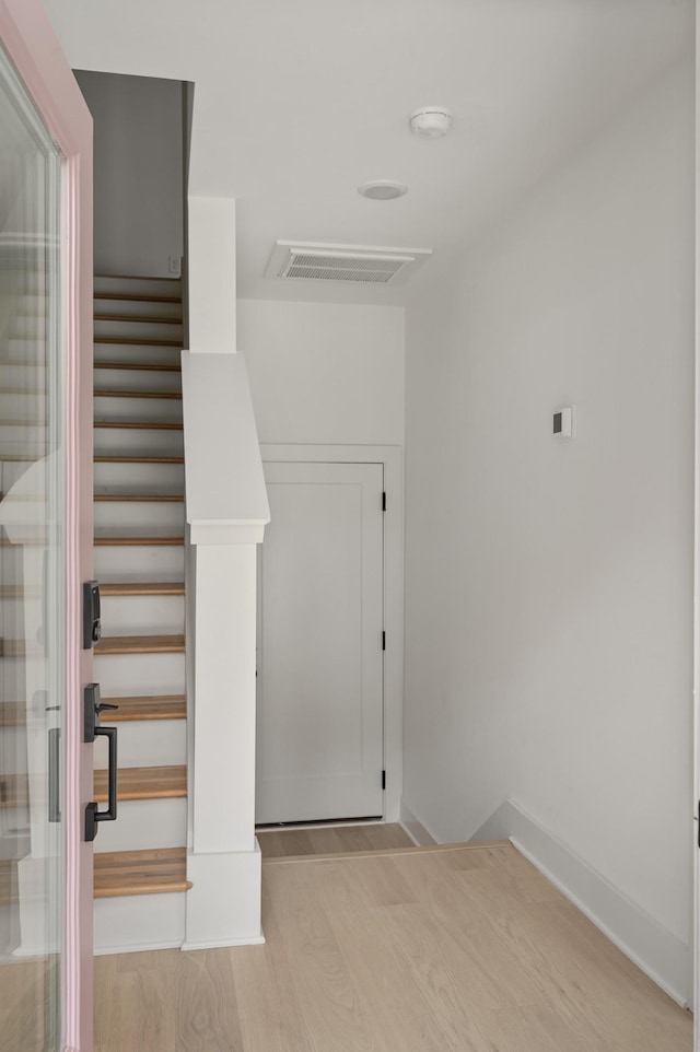 staircase with hardwood / wood-style flooring