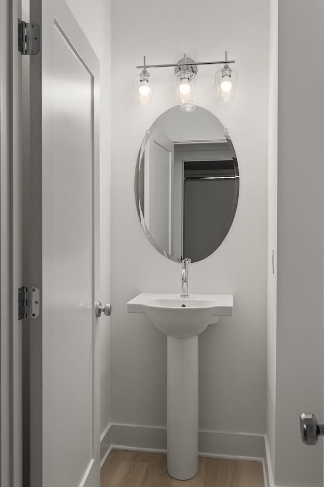 bathroom with hardwood / wood-style flooring and sink