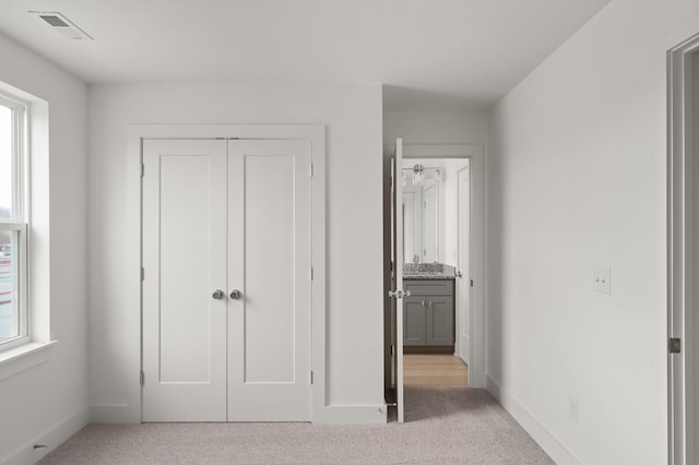 unfurnished bedroom featuring light colored carpet