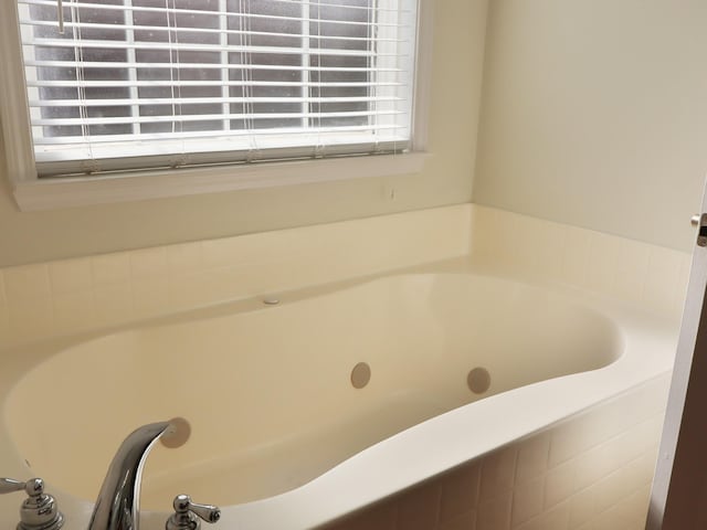 bathroom with tiled bath