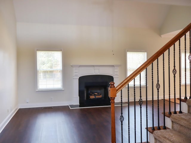 stairs with hardwood / wood-style flooring and vaulted ceiling