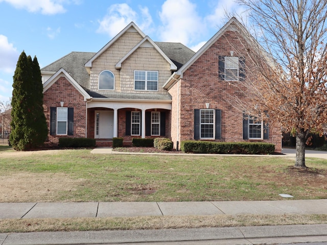 view of front of house with covered porch and a front yard