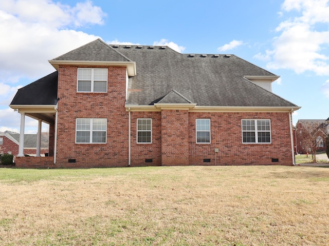 rear view of property with a lawn