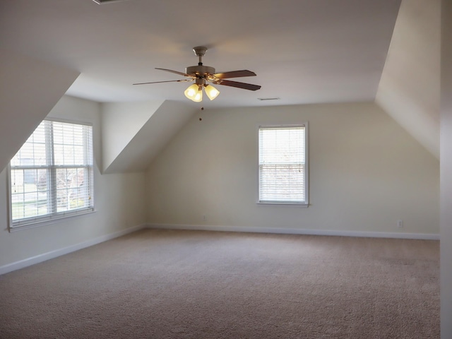 additional living space featuring light carpet, ceiling fan, and lofted ceiling