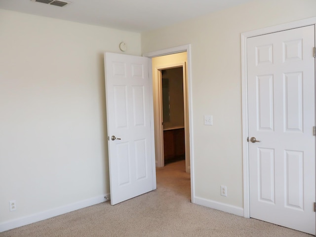 unfurnished bedroom with light colored carpet