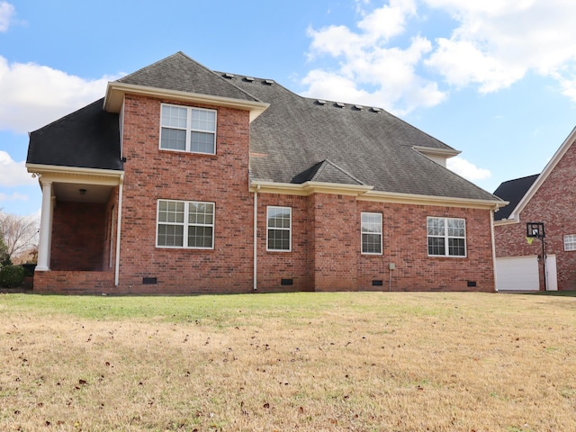 rear view of house featuring a lawn