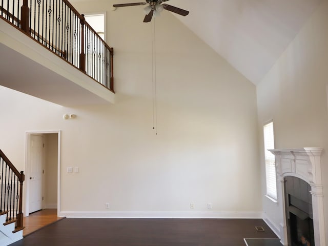 unfurnished living room featuring hardwood / wood-style flooring, high vaulted ceiling, and ceiling fan