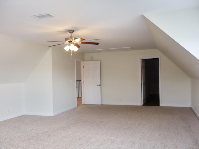 additional living space featuring light carpet, ceiling fan, and lofted ceiling