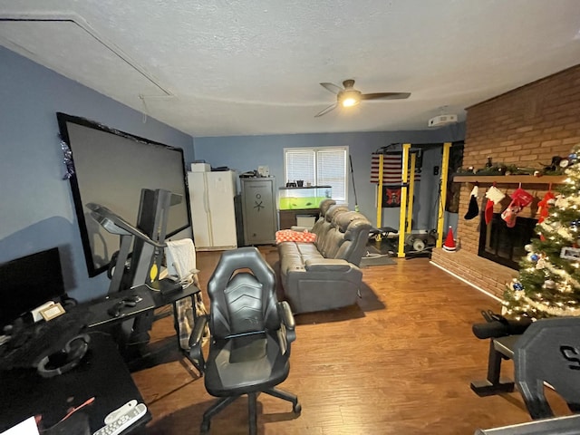 office area with hardwood / wood-style floors, ceiling fan, and a textured ceiling