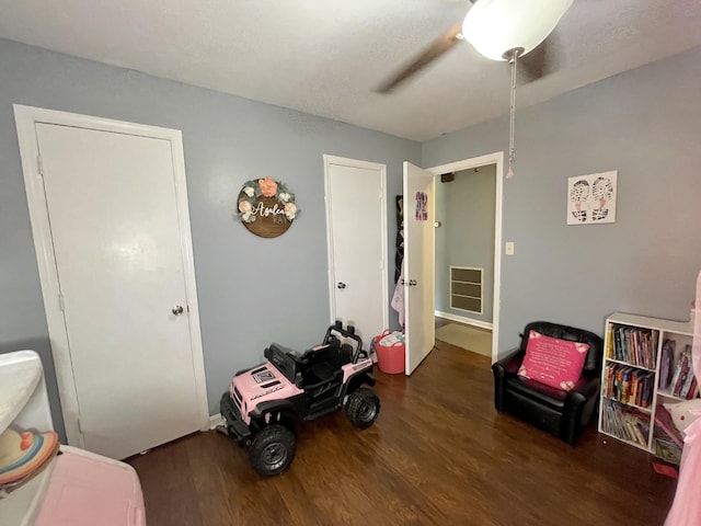 sitting room with dark hardwood / wood-style flooring and ceiling fan