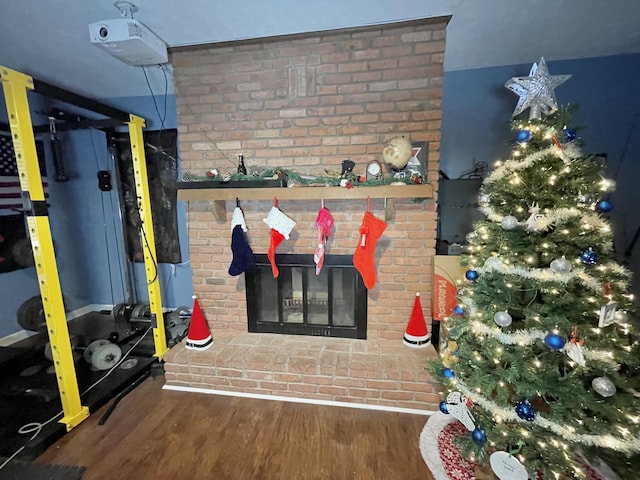 details featuring hardwood / wood-style flooring and a brick fireplace