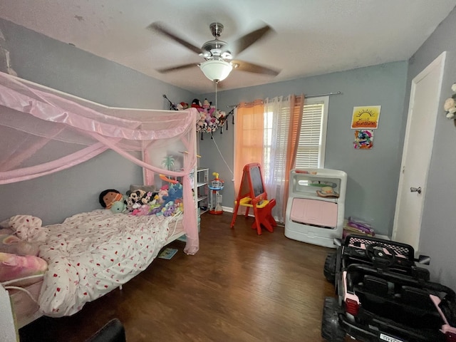 bedroom with ceiling fan and dark hardwood / wood-style floors