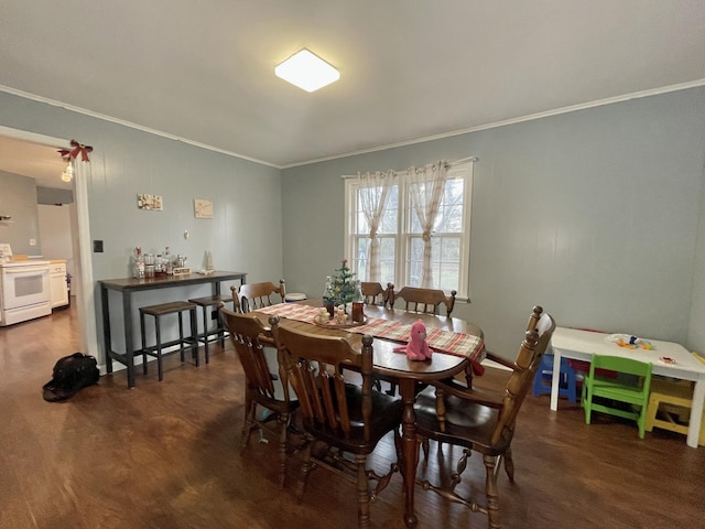 dining room with dark wood-type flooring and ornamental molding