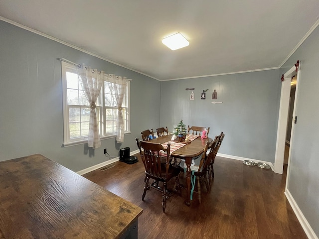 dining room with ornamental molding and dark wood-type flooring