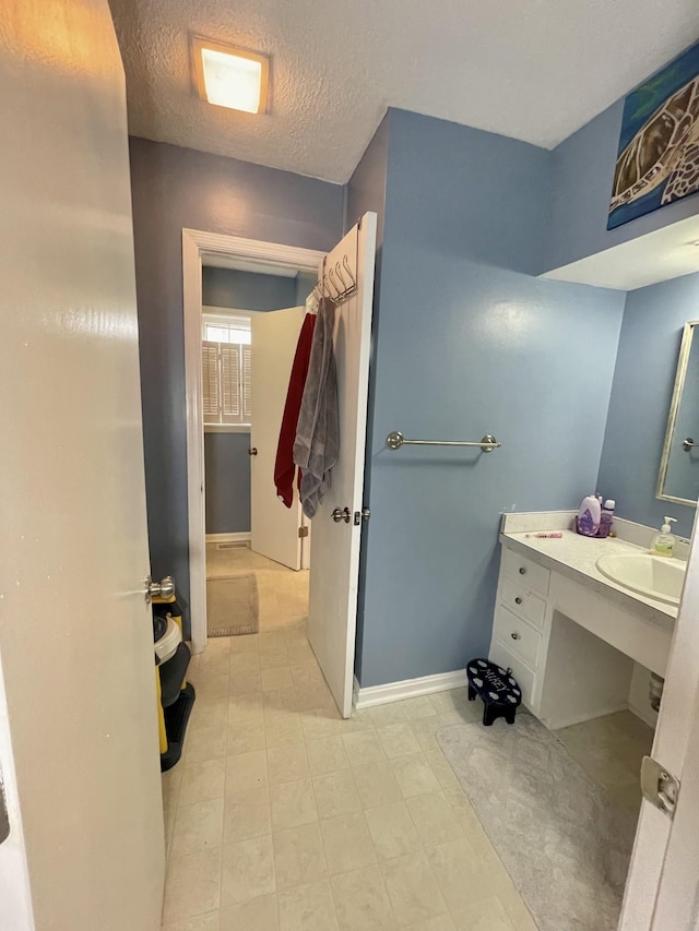 bathroom featuring vanity and a textured ceiling