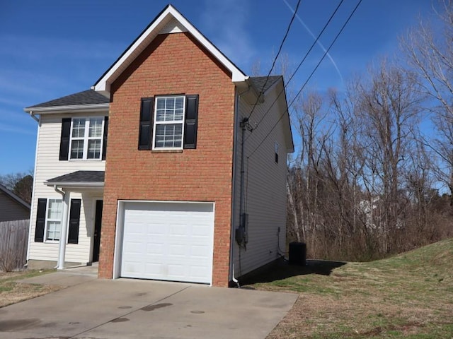 traditional home featuring a garage, driveway, and brick siding