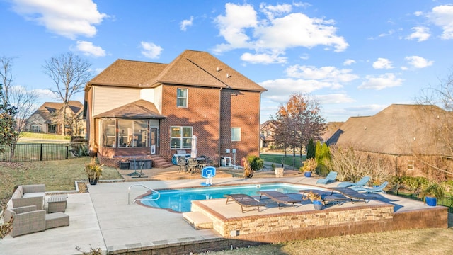 view of pool with a patio area and a sunroom