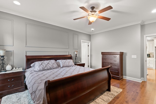 bedroom with ceiling fan, crown molding, and light hardwood / wood-style flooring