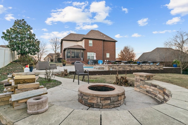 view of patio featuring a pool and a fire pit