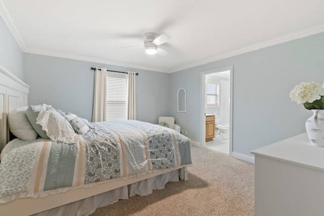 carpeted bedroom featuring ceiling fan, ensuite bath, and ornamental molding