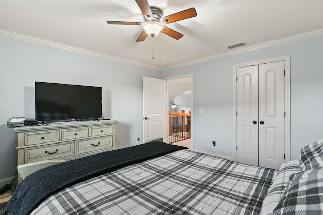 bedroom with ceiling fan, a closet, and crown molding