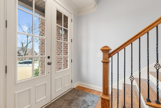 entryway with crown molding and hardwood / wood-style flooring