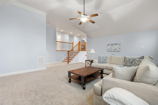 carpeted living room featuring ceiling fan and ornamental molding