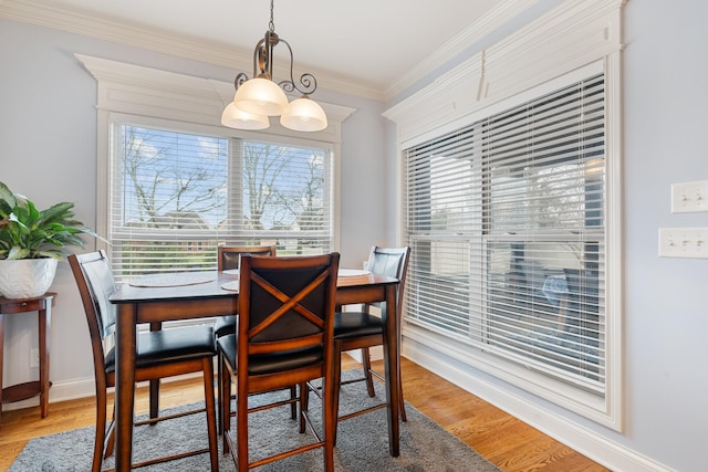 dining room featuring hardwood / wood-style flooring and ornamental molding