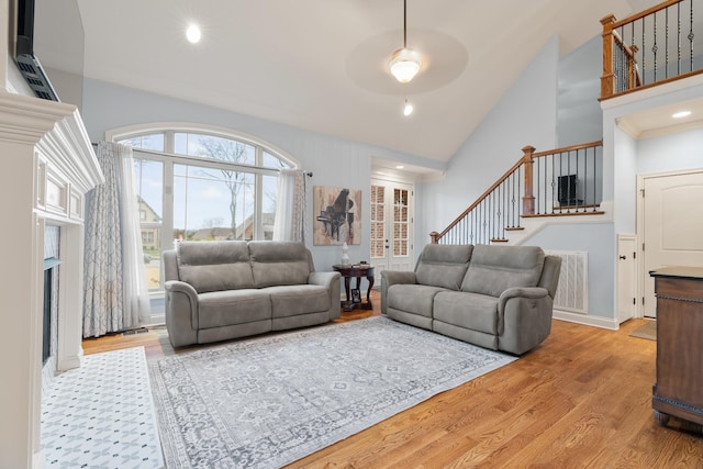 living room with light wood-type flooring and ceiling fan