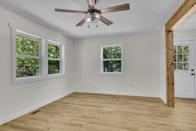 unfurnished room with light hardwood / wood-style flooring, a wealth of natural light, and ceiling fan