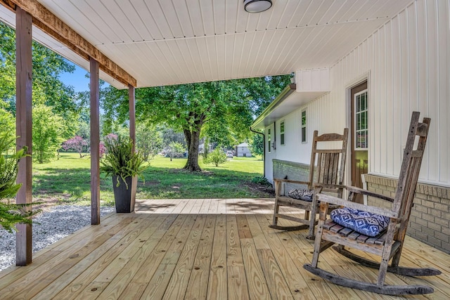 wooden terrace featuring a yard