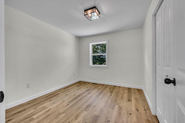 spare room with light wood-type flooring